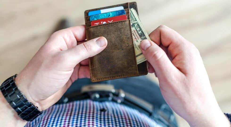 man pulling money out of wallet
