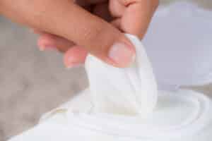 Closeup woman hand holding wet wipes from package. healthcare, people and medicine concept.