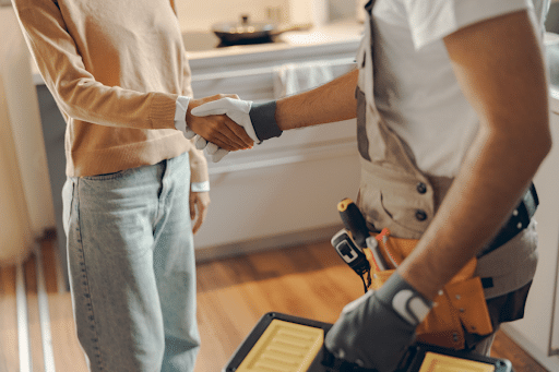 Plumber and homeowner shaking hands after a successful plumbing maintenance appointment