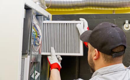 Technician repairing furnace.