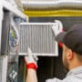 Technician repairing furnace.