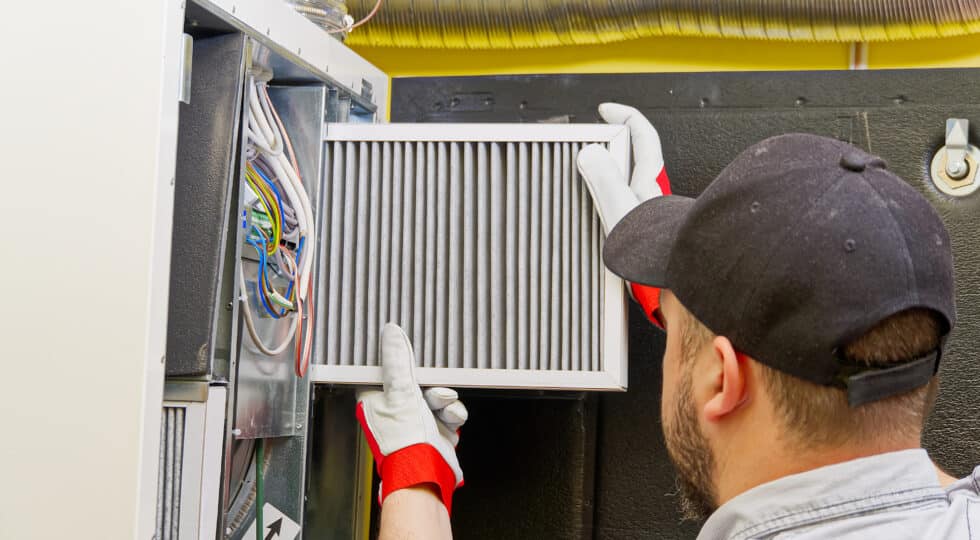 Technician repairing furnace.