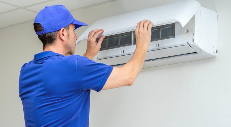 Technician installing a heat pump system.